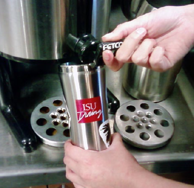 Person filling their reusable mug with coffee