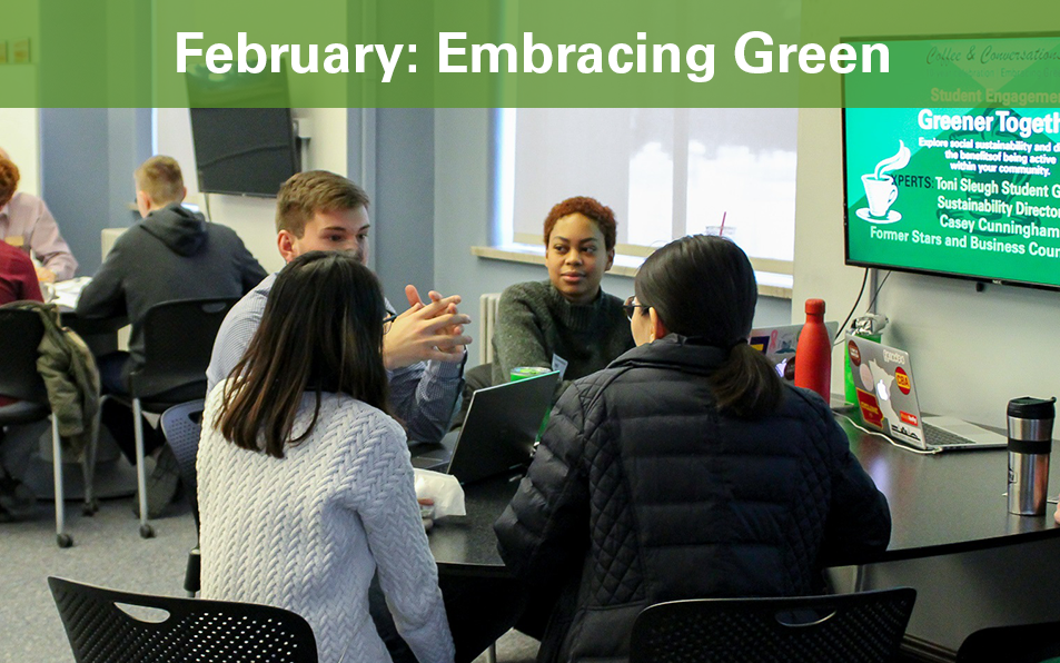 Students sit at table discussing sustainable topic during 10 year Embracing Green Event.