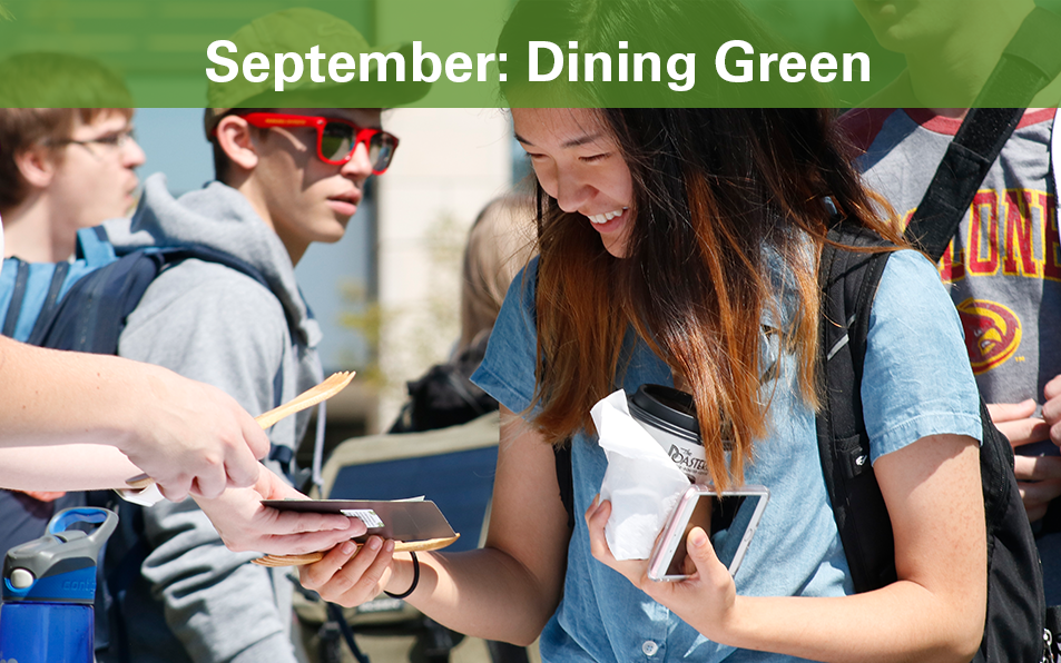 Student looks at handouts during Dining Green Event