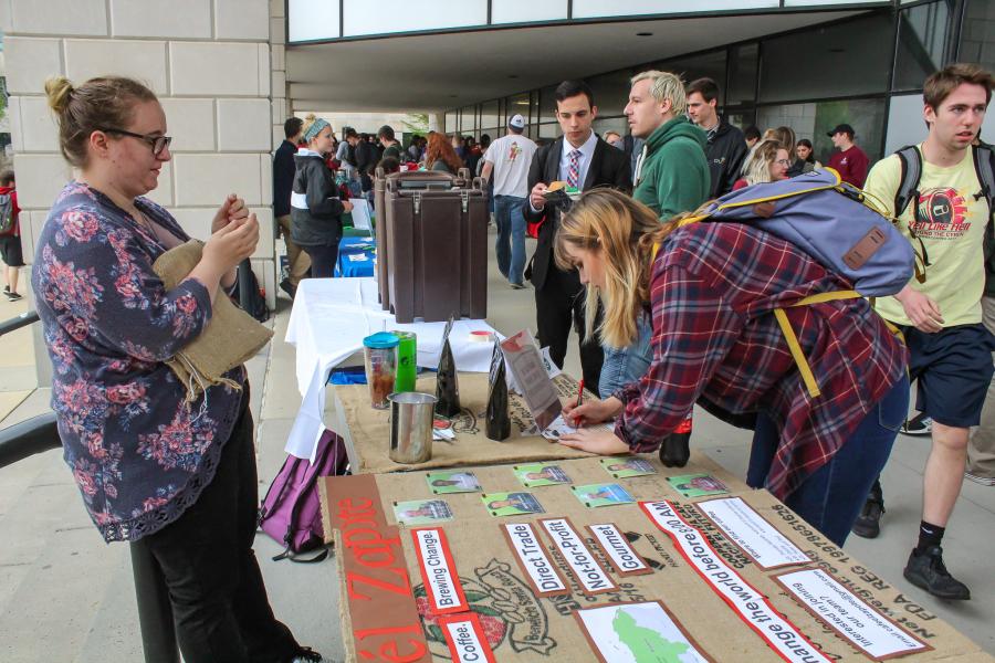 Tables supplied with student organization fliers are viewed by participants. 