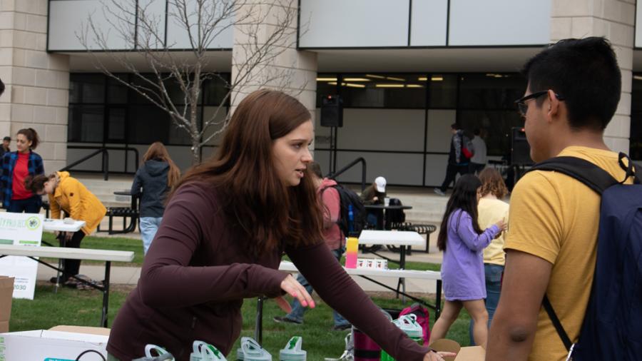 Students set up tables at the Earth day event. 