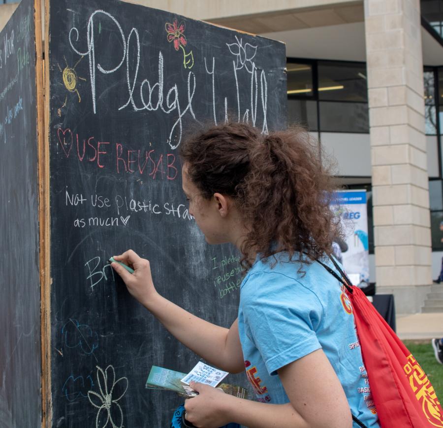 Students wrote down their commitment to sustainability on a chalk board. 