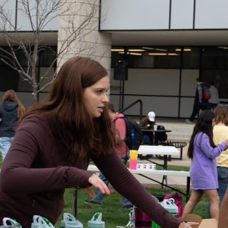 Students set up tables at the Earth day event. 